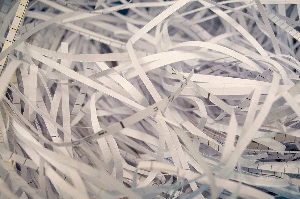 Securely shredded confidential paper documents